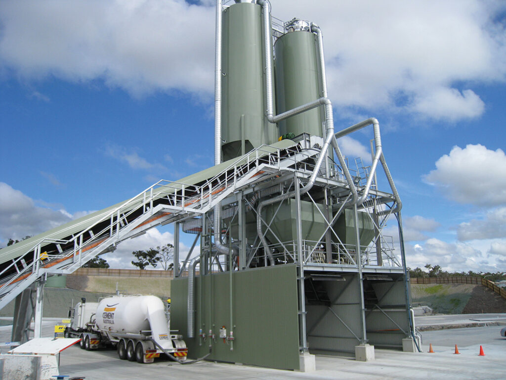 New green and silver storage silos on the site of a quarry | Featured image for Mobile Equipment Landing Page for CMQ Engineering USA.