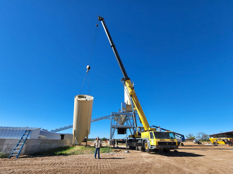 Raising a chisel nose silo during installation of an Advantage 250 concrete batch plant in Texas