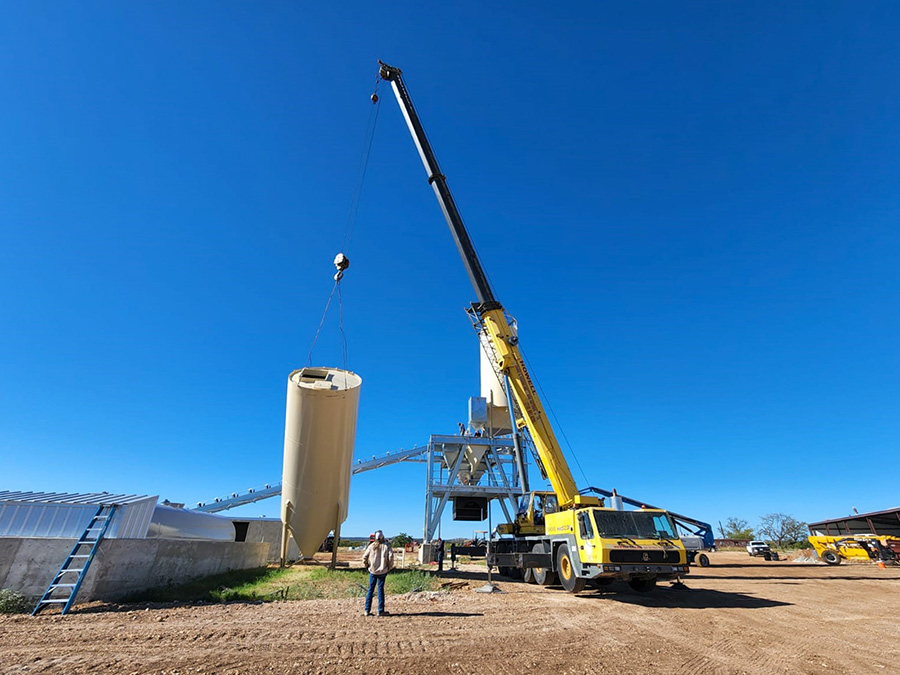 Raising a chisel nose silo during installation of an Advantage 250 concrete batch plant in Texas