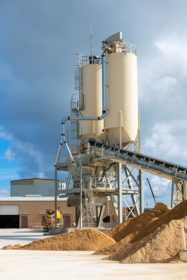 Chisel-nose silos for cement and fly ash at ready-mix concrete facility in central Texas.