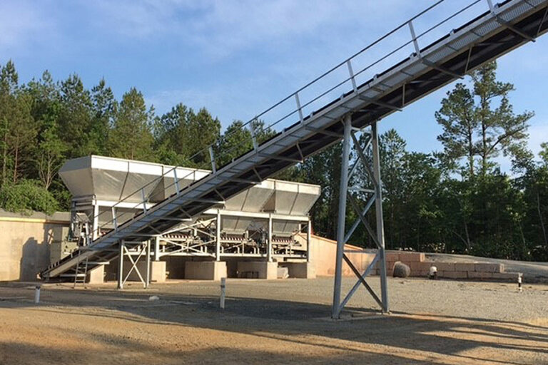 Ready mixed concrete plant in North Carolina, with aggregate blending unit set at 90 degrees to the charging conveyor.
