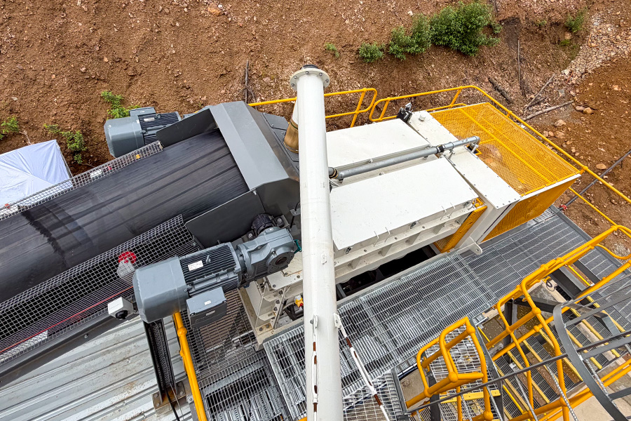 View of a CMQ Engineering paste backfill plant, showing the point where the trailings conveyor and cement auger discharge into the plant's powerful twin-shaft mixer.
