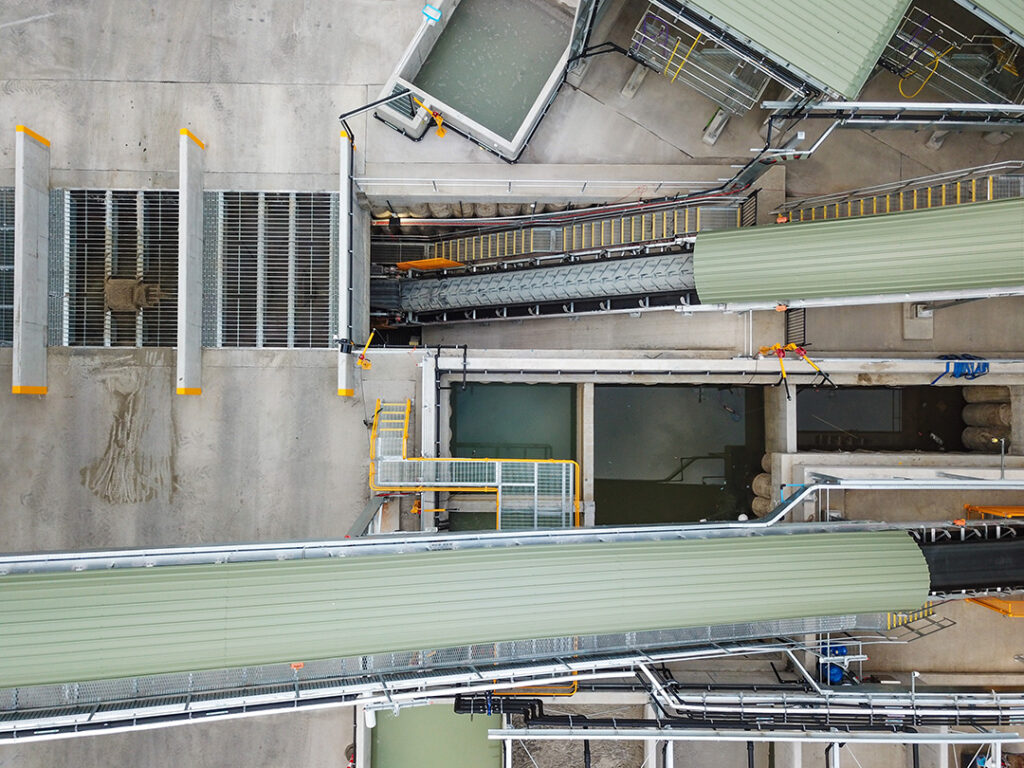 Overhead view shows the drive-over receiving grates and aggregate loading conveyor.